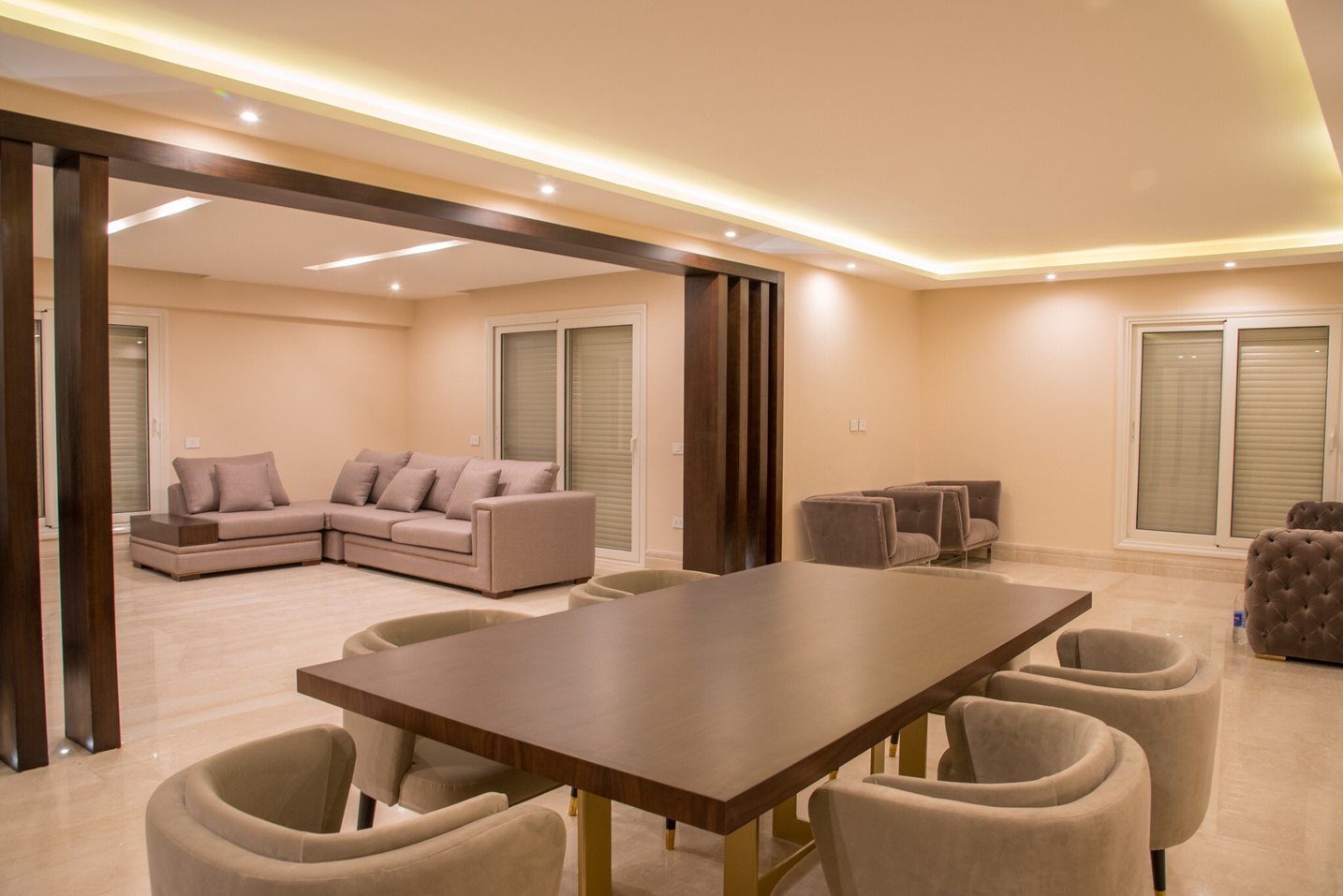 Living and dining room with a timber dining table and cove lighting