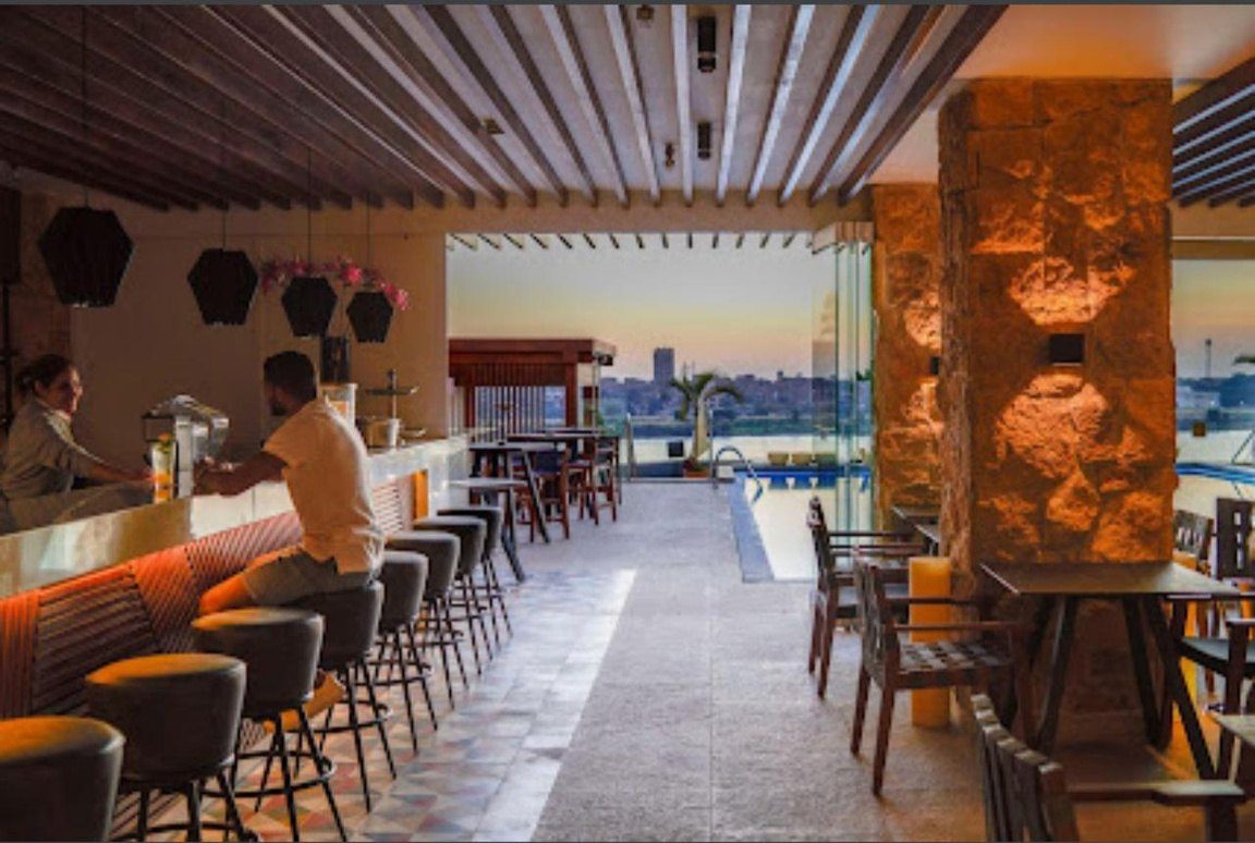 Restaurant terrace with a timber-slatted ceiling overlooking the water