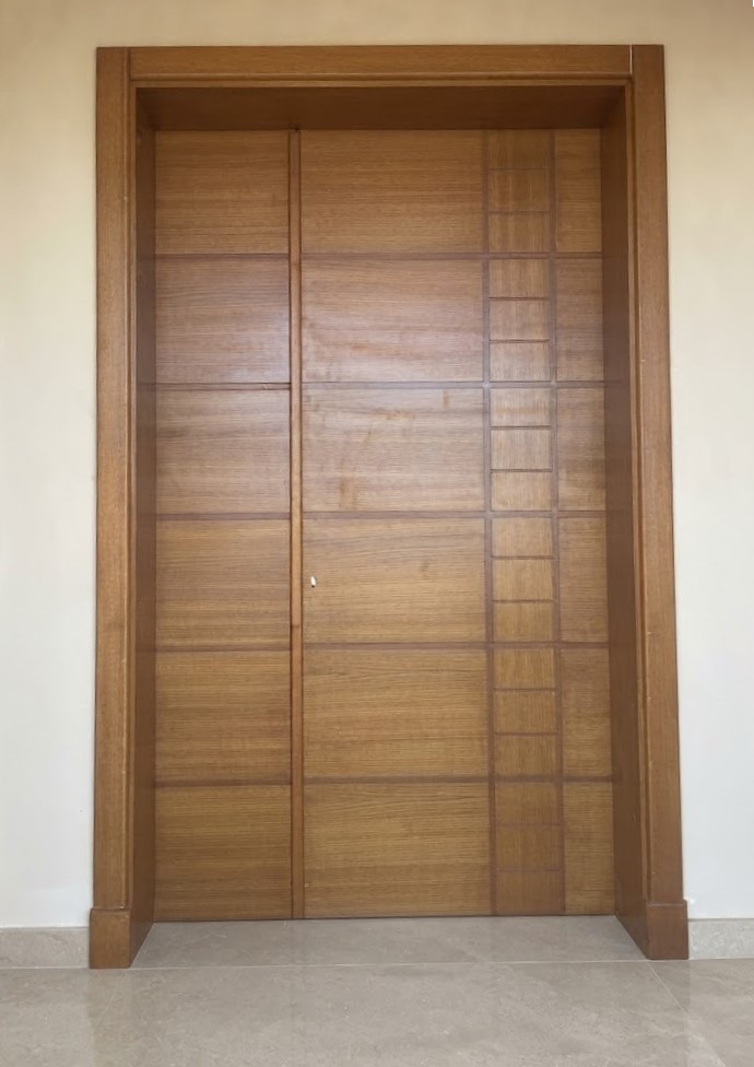 Double timber entrance door with inlaid grooves in a deep timber frame