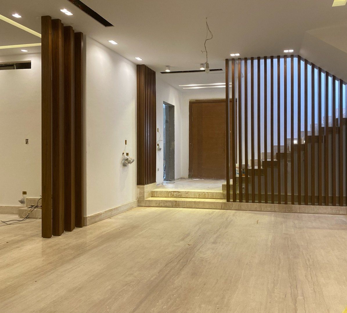 Stair hall with a vertical timber-slat balustrade screen